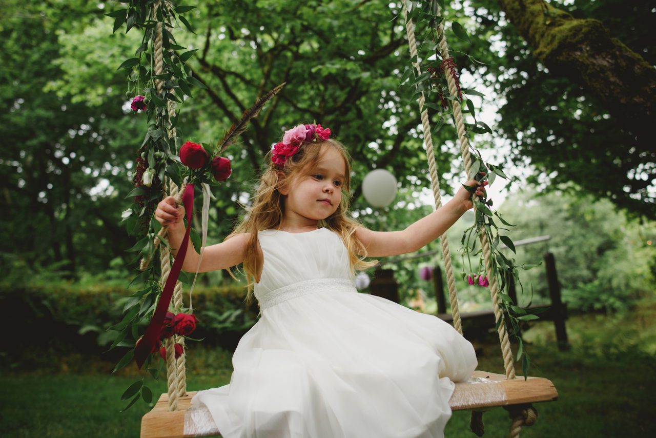 Child on a swing during a wedding in Cornwall. Wedding planned by Jenny Wren Cornwall Wedding Planner