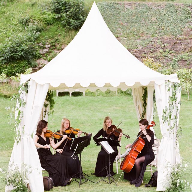 String quartet playing at Sarah and Mark's wedding in Cornwall. This wedding was planned by Jenny Wren, wedding  and event planner in Cornwall