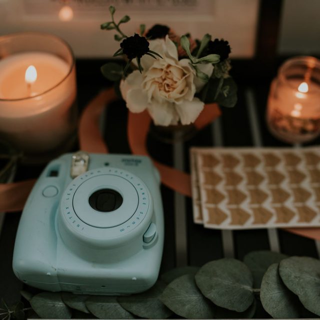 polaroid camera and candles on table at Trevibban Mill in Cornwall