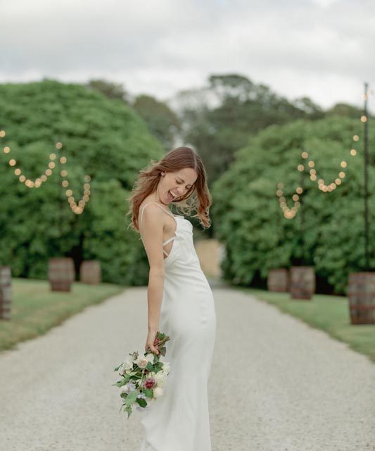Bride posing and celebrating at Boconnoc House in Cornwall. This wedding in Cornwall was planned by Jenny Wren - wedding planner.