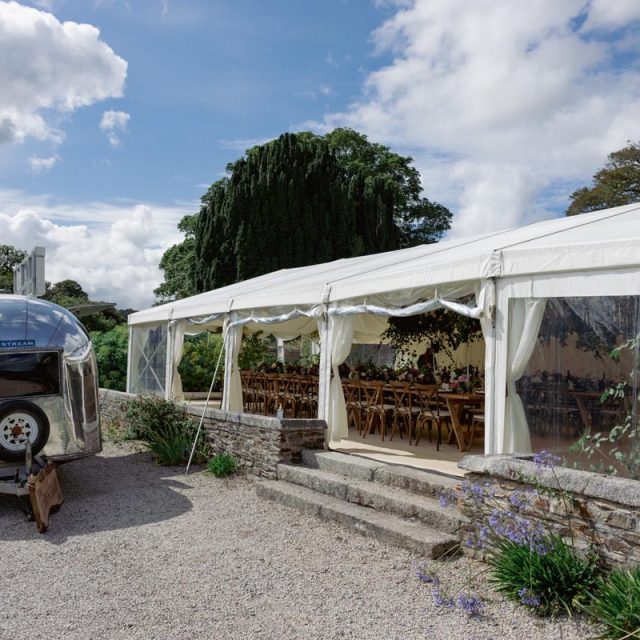 Picture of a trailer and gazebo where the wedding breakfast would be held. This wedding in Cornwall was planned by Jenny Wren - wedding planner.